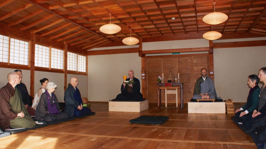 Dharma-Befragung im Zendo: der Shuso liest den Fall vor, die Übenden sitzen an den Wänden.